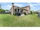 Spacious backyard featuring a well-maintained lawn, patio with grill, and mature trees at 5920 Hart Way, Cumming, GA 30028