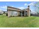 A spacious backyard features manicured lawn, landscaping, and a screened porch at 5920 Hart Way, Cumming, GA 30028