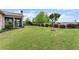 A spacious backyard featuring manicured lawn, landscaping, and shade trees at 5920 Hart Way, Cumming, GA 30028