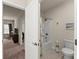 Bathroom featuring a tub/shower combination, toilet, and tile flooring at 5920 Hart Way, Cumming, GA 30028