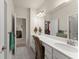 Bathroom featuring a dual sink vanity and adjacent rooms at 5920 Hart Way, Cumming, GA 30028