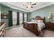 Bedroom with carpet, tray ceiling, ceiling fan, and natural light from multiple windows at 5920 Hart Way, Cumming, GA 30028
