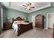 Spacious primary bedroom featuring a tray ceiling, carpet and elegant furnishings at 5920 Hart Way, Cumming, GA 30028