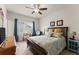 Bright bedroom with a comfortable bed, natural light, and a ceiling fan at 5920 Hart Way, Cumming, GA 30028