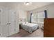 Cozy bedroom with a double door closet, natural light, and neutral carpet at 5920 Hart Way, Cumming, GA 30028