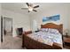 Comfortable bedroom with a decorative headboard, ceiling fan, and access to an adjoining bathroom at 5920 Hart Way, Cumming, GA 30028