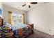 Bright bedroom featuring a ceiling fan, natural light, and window views at 5920 Hart Way, Cumming, GA 30028