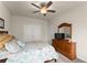 Comfortable bedroom featuring a ceiling fan, dresser, and neutral color scheme at 5920 Hart Way, Cumming, GA 30028