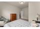 Inviting bedroom with a neutral palette, comfortable bed, and an open doorway at 5920 Hart Way, Cumming, GA 30028