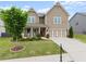 Charming two-story home featuring a covered porch and a well-maintained lawn at 5920 Hart Way, Cumming, GA 30028