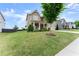 Charming two-story home featuring a covered porch and a well-maintained lawn at 5920 Hart Way, Cumming, GA 30028