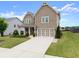 Charming two-story home featuring a covered porch and a well-maintained lawn at 5920 Hart Way, Cumming, GA 30028