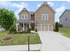 Charming two-story home featuring a covered porch and a well-maintained lawn at 5920 Hart Way, Cumming, GA 30028
