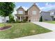 Charming two-story home featuring a covered porch and a well-maintained lawn at 5920 Hart Way, Cumming, GA 30028