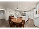 Open-concept kitchen with island seating flowing into a dining area and staircase, providing easy access at 5920 Hart Way, Cumming, GA 30028