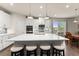 Spacious kitchen with large center island, pendant lighting, stainless appliances, and modern finishes at 5920 Hart Way, Cumming, GA 30028