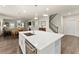 Open-concept kitchen features a large island with modern appliances and easy access to the living area at 5920 Hart Way, Cumming, GA 30028