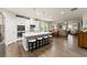 Bright, open concept kitchen features an oversized island with stool seating and stainless appliances at 5920 Hart Way, Cumming, GA 30028