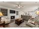 A bright living room featuring a fireplace, stylish decor, and hardwood flooring at 5920 Hart Way, Cumming, GA 30028