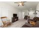 Spacious living room featuring a ceiling fan, wood accents, and neutral carpet, great for relaxation at 5920 Hart Way, Cumming, GA 30028