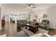 Open concept living room with hardwood floors and view to the kitchen with stainless appliances at 5920 Hart Way, Cumming, GA 30028