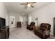 Spacious living area with comfortable leather seating and a view into adjacent rooms at 5920 Hart Way, Cumming, GA 30028