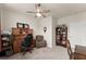 Well-lit office space with classic wooden furniture, a comfortable chair, and carpet flooring at 5920 Hart Way, Cumming, GA 30028