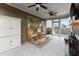 Relaxing screened porch with rocking chairs, ceiling fans, and a view of the backyard at 5920 Hart Way, Cumming, GA 30028