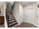 Elegant staircase with decorative tile risers and wrought iron railing at 5920 Hart Way, Cumming, GA 30028