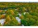 Aerial view of the home in a verdant neighborhood setting with mature trees and city skyline in the distance at 1285 Wesley Nw Pl, Atlanta, GA 30327