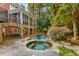 The backyard features a covered porch, pool, spa, and extensive landscaping for an inviting outdoor space at 1285 Wesley Nw Pl, Atlanta, GA 30327