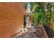 Brick home with a private entrance to the backyard featuring mature landscaping and a secure fence at 1285 Wesley Nw Pl, Atlanta, GA 30327