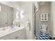 Bathroom featuring sleek shower stall, clean white vanity, and blue-and-white tiled flooring at 1285 Wesley Nw Pl, Atlanta, GA 30327