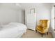 Inviting bedroom with plantation shutters, classic accents, and a yellow velvet chair at 1285 Wesley Nw Pl, Atlanta, GA 30327
