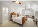 Bright bedroom with two twin beds, ceiling fan, and walk-in closet with built-in shelving, bathed in natural light at 1285 Wesley Nw Pl, Atlanta, GA 30327