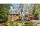 Traditional brick home with a manicured lawn, mature trees, and a charming porte-cochere at 1285 Wesley Nw Pl, Atlanta, GA 30327