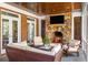 Screened porch with a stone fireplace with TV and plush outdoor seating at 1285 Wesley Nw Pl, Atlanta, GA 30327