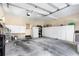 Spacious garage featuring ample storage cabinets, a white refrigerator, and a convenient entry door at 1285 Wesley Nw Pl, Atlanta, GA 30327
