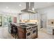 Gourmet kitchen with a stone floor, island with range, and barstool seating at 1285 Wesley Nw Pl, Atlanta, GA 30327