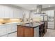 Gourmet kitchen with white cabinets, backsplash, an island and stainless steel appliances at 1285 Wesley Nw Pl, Atlanta, GA 30327