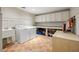 Bright laundry room with washer, dryer, ample counter space, and built-in storage cabinets at 1285 Wesley Nw Pl, Atlanta, GA 30327