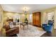 Cozy living room with a hardwood floor, stylish seating, and a wooden armoire at 1285 Wesley Nw Pl, Atlanta, GA 30327