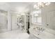 Bright primary bathroom featuring white tile, glass shower, and access to a walk-in closet and bathtub at 1285 Wesley Nw Pl, Atlanta, GA 30327