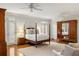 Spacious main bedroom with 4-poster bed, hardwood floors, and access to a balcony at 1285 Wesley Nw Pl, Atlanta, GA 30327
