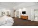 Spacious main bedroom featuring a TV, hardwood furnishings, and access to the en suite bathroom at 1285 Wesley Nw Pl, Atlanta, GA 30327