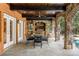 Covered outdoor kitchen with stone arches, a built-in grill, and adjacent pool area for entertaining at 1285 Wesley Nw Pl, Atlanta, GA 30327