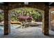 Stone archway view to pool area with hot tub and lush landscaping at 1285 Wesley Nw Pl, Atlanta, GA 30327