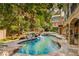 Luxurious backyard pool and rock waterfall feature nestled among lush landscaping and mature trees at 1285 Wesley Nw Pl, Atlanta, GA 30327