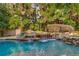 Beautiful backyard pool featuring rock waterfall feature, lush landscaping and separate spa area at 1285 Wesley Nw Pl, Atlanta, GA 30327