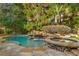 Backyard with a custom pool, waterfall feature, lush landscaping, and a separate spa area at 1285 Wesley Nw Pl, Atlanta, GA 30327